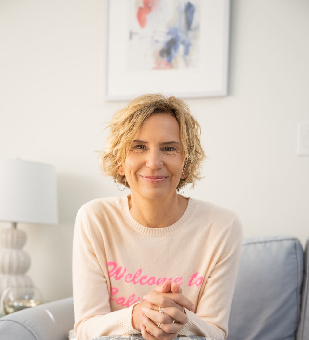 Michelle Grossman sitting at home, smiling warmly at the camera
